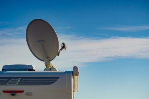 Satellite dish on roof of caravan Travel holidays in motorhome. Satellite dish on roof of camper car. TV connection.